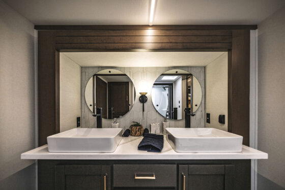 Bathroom interior of the 2025 Heartland RV Bighorn 391MFB Fifth Wheel featuring a modern vanity and sink.