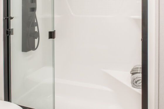 Interior of the 2025 Heartland RV Bighorn 391MFB Fifth Wheel bathroom featuring a spacious shower.