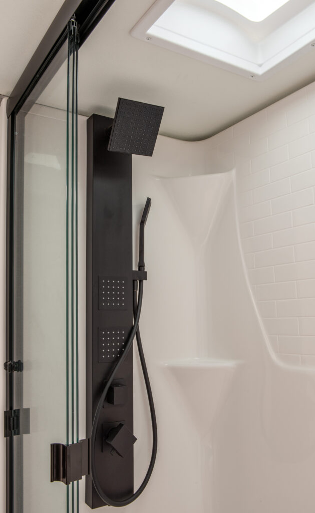 Shower head and interior of the bathroom in the 2025 Heartland RV Bighorn 391MFB Fifth Wheel.