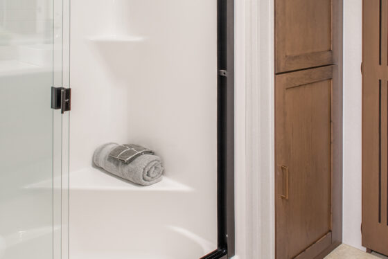Interior bathroom of the 2025 Heartland RV Bighorn 391MFB Fifth Wheel featuring a toilet and shower.