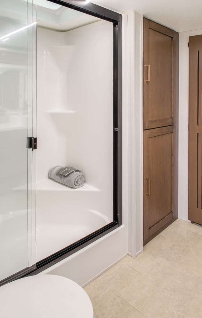 Interior bathroom of the 2025 Heartland RV Bighorn 391MFB Fifth Wheel featuring a toilet and shower.