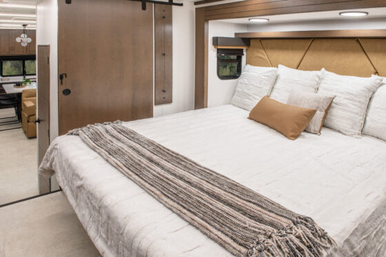 King-size bed in the 2025 Heartland RV Bighorn 391MFB Fifth Wheel bedroom.