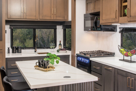 Interior kitchen of the 2025 Heartland RV Bighorn 391MFB Fifth Wheel with modern appliances and sleek finishes.