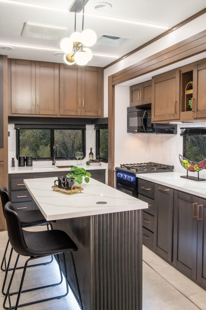 Interior kitchen of the 2025 Heartland RV Bighorn 391MFB Fifth Wheel with modern appliances and sleek finishes.
