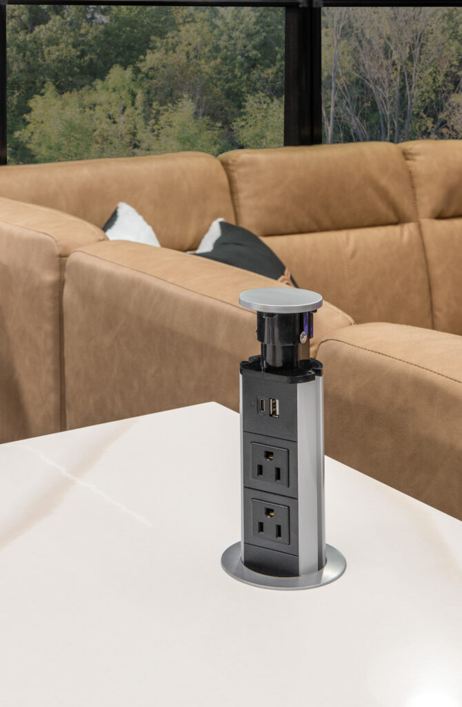 Interior of the 2025 Heartland RV Bighorn 391MFB Fifth Wheel, featuring a kitchen countertop with a power outlet.