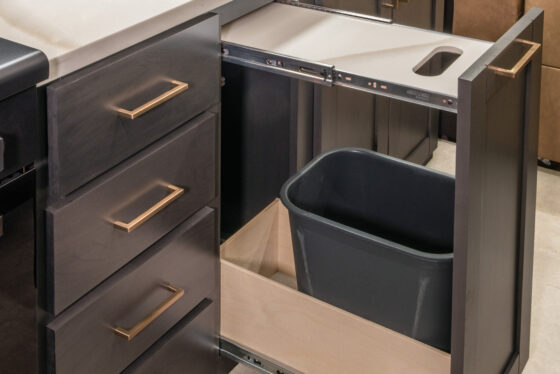 Interior of the 2025 Heartland RV Bighorn 391MFB Fifth Wheel kitchen with a cutting board integrated into the countertop.