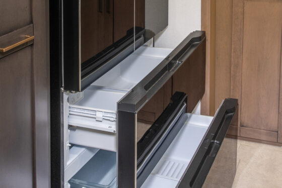 Interior of the 2025 Heartland RV Bighorn 391MFB Fifth Wheel showing the kitchen with a large refrigerator.