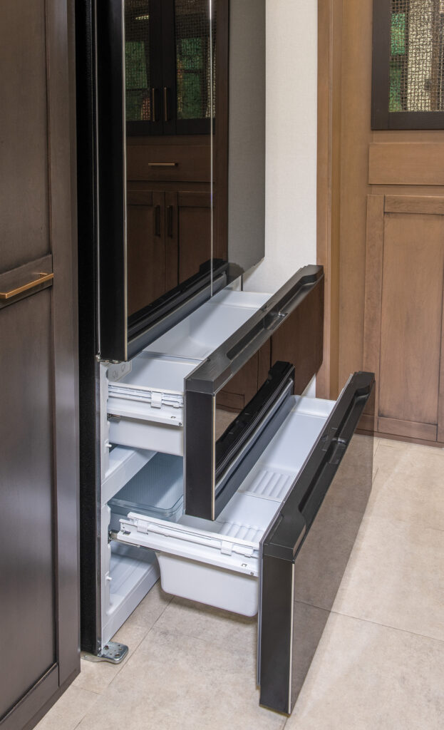 Interior of the 2025 Heartland RV Bighorn 391MFB Fifth Wheel showing the kitchen with a large refrigerator.