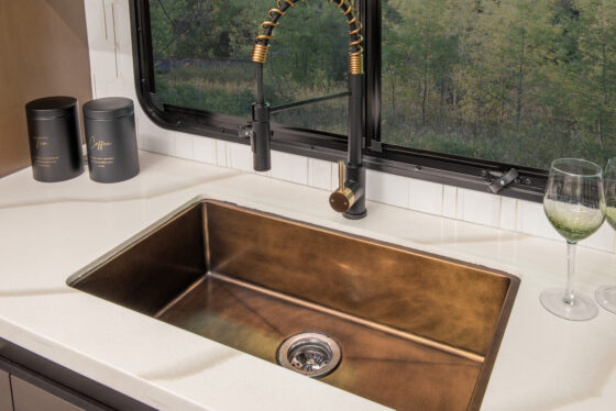 Interior of the 2025 Heartland RV Bighorn 391MFB Fifth Wheel showing kitchen sink with modern faucet.