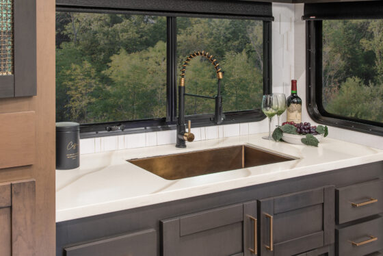 Interior of the 2025 Heartland RV Bighorn 391MFB Fifth Wheel kitchen showing the sink area and cabinets.