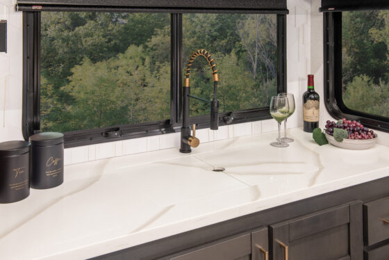 2025 Heartland RV Bighorn 391MFB Fifth Wheel kitchen featuring a closed kitchen sink cover.