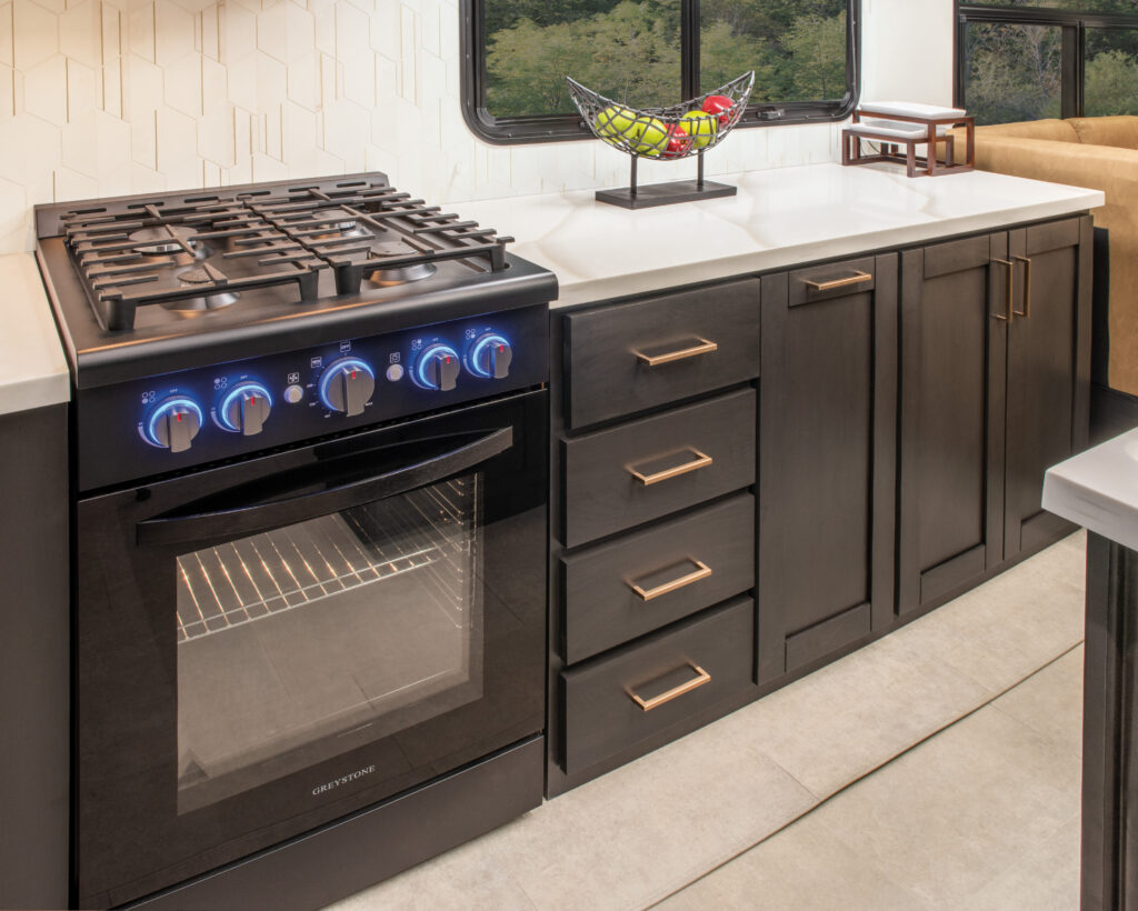 Interior of the 2025 Heartland RV Bighorn 391MFB Fifth Wheel kitchen showing the stove and countertops.