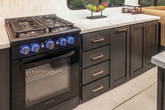 Interior of the 2025 Heartland RV Bighorn 391MFB Fifth Wheel kitchen showing the stove and countertops.