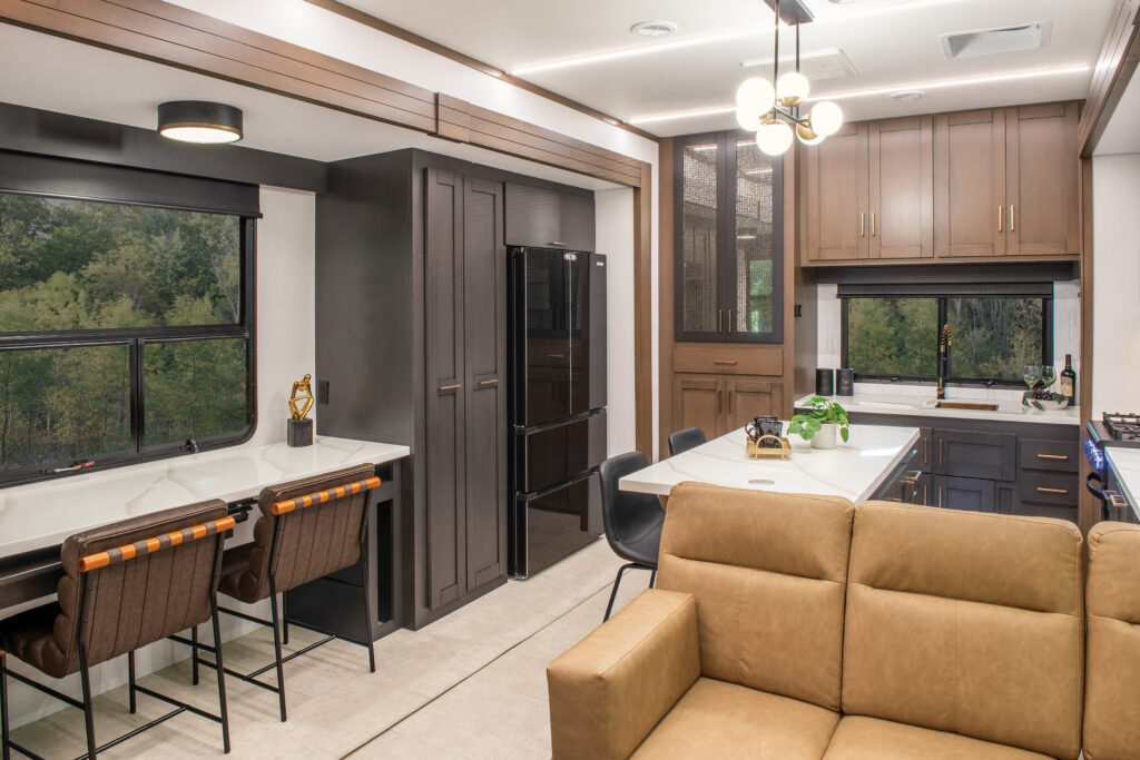2025 Heartland RV Bighorn 391MFB Fifth Wheel kitchen featuring a swing-out desk and modern appliances.