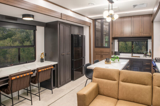 2025 Heartland RV Bighorn 391MFB Fifth Wheel kitchen featuring a swing-out desk and modern appliances.