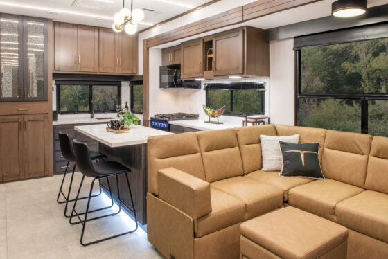 Interior of the 2025 Heartland RV Bighorn 391MFB Fifth Wheel, featuring the living room and kitchen with modern finishes.