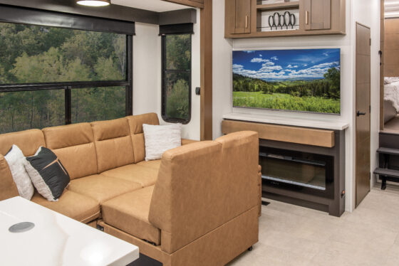Interior of the 2025 Heartland RV Bighorn 391MFB Fifth Wheel, showcasing a comfortable living room with a cozy sofa.