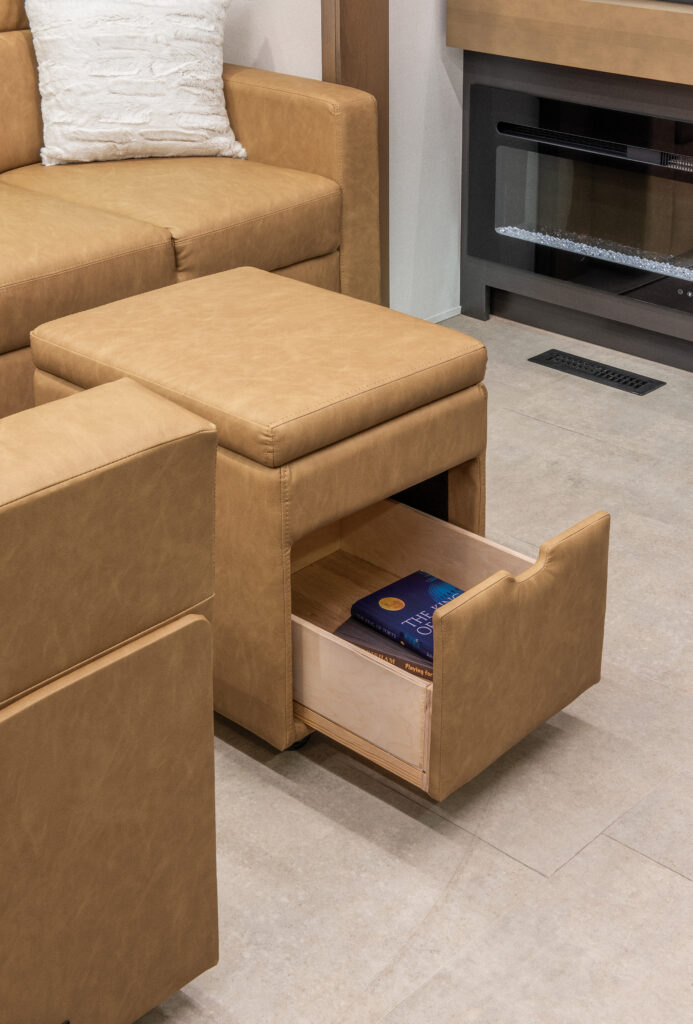 Interior of the 2025 Heartland RV Bighorn 391MFB Fifth Wheel, featuring a living room sofa with hidden storage.