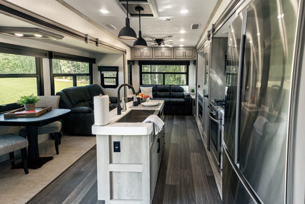 A view of the Heartland Big Country interior, showing off a kitchen and living space.