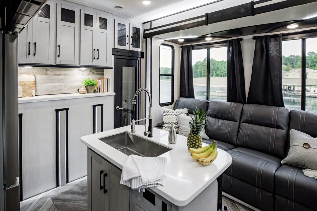 A wide view of the Heartland Cyclone interior, showing off a kitchen and living space.