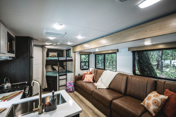 Interior view of a Heartland RV, showcasing the kitchen area and dining space.