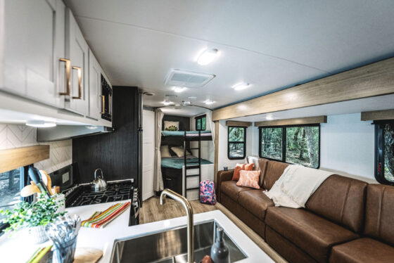A sleek kitchen inside a Heartland RV, featuring modern appliances and ample countertop space.