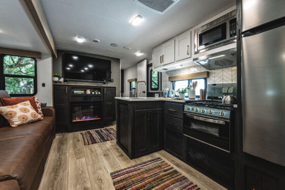 A spacious and modern living area inside a Heartland RV, featuring comfortable seating and decorative accents.