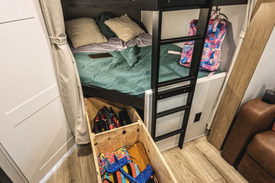 Interior view of a Heartland RV, showcasing the bedroom area and living space.
