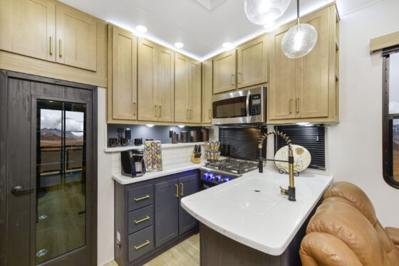 Interior of the 2024 Heartland Cyclone 4006 featuring a modern kitchen, spacious living area, and stylish furnishings.