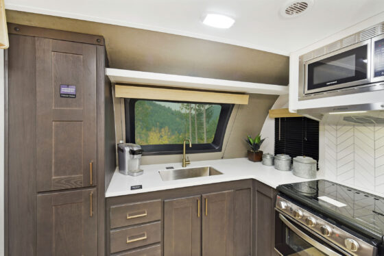 A well-appointed kitchen inside a Heartland RV, featuring modern appliances and ample storage.