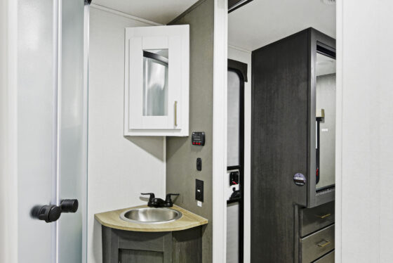 A spacious bathroom inside a Heartland RV, featuring modern fixtures and ample storage.