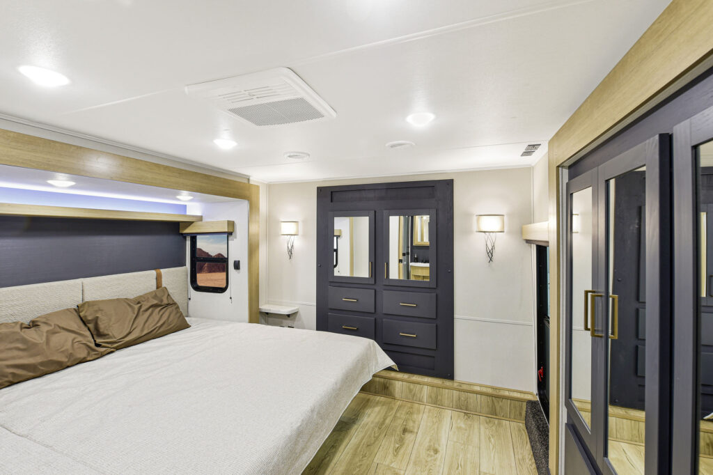 Heartland Torque RV bedroom featuring a king-sized bed with ample storage space.