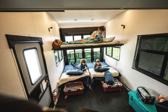 Interior view of a loft with two beds underneath in a Heartland RV, showcasing efficient space utilization.
