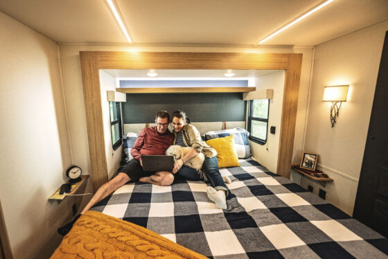 Queen-size bed inside a Heartland Torque RV, offering comfort and space for restful nights on the road.