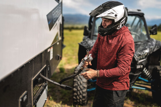 An ATV being plugged into the Heartland Torque RV, showcasing the RV's connectivity and utility features.