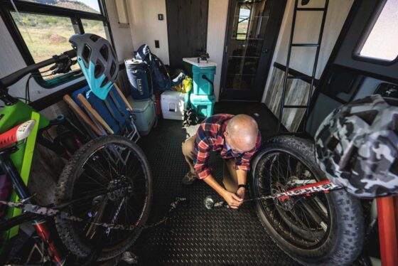 Spacious garage area inside a Heartland Cyclone toy hauler, featuring durable flooring, overhead storage, and tie-downs for securing cargo or recreational vehicles.