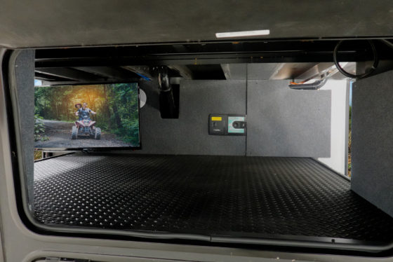 Small enclosed storage space inside the 2024 Heartland Cyclone Toy Hauler with a simple, open design.
