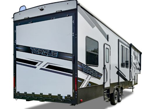 Side view of the Heartland Torque fifth wheel RV, featuring its exterior design and large storage compartments.