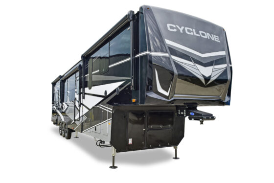 Exterior view of a Heartland RV with a large awning extended, showcasing the RV's sleek design and outdoor living space.