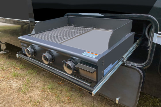 Heartland RV’s Grill-N-Go outdoor cooking station with a pull-out propane grill and storage drawer.