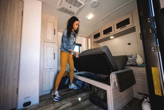 Pull away bed in a Sundance Ultra Lite travel trailer, folded up against the wall to maximize space.
