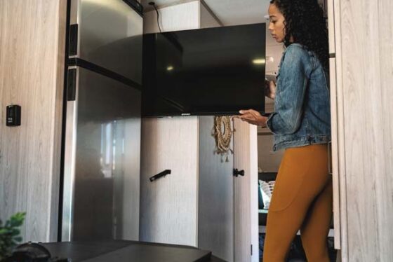TV storage slot in a Sundance Ultra Lite travel trailer, providing a secure space to stow away the television when not in use.