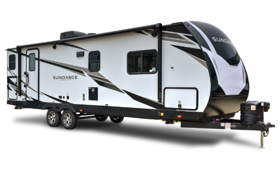 Front view of a sleek, modern Sundance 2023 RV parked in a scenic outdoor setting.
