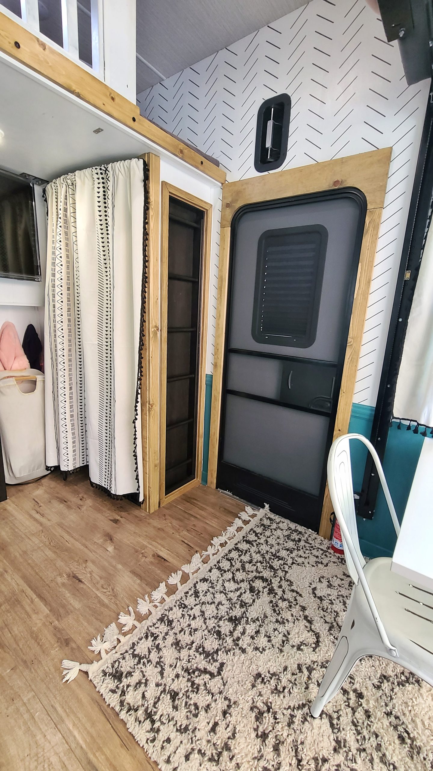 A view of an RV loft space and door.