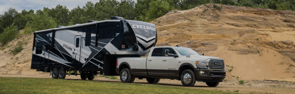 A truck towing a Cyclone RV.