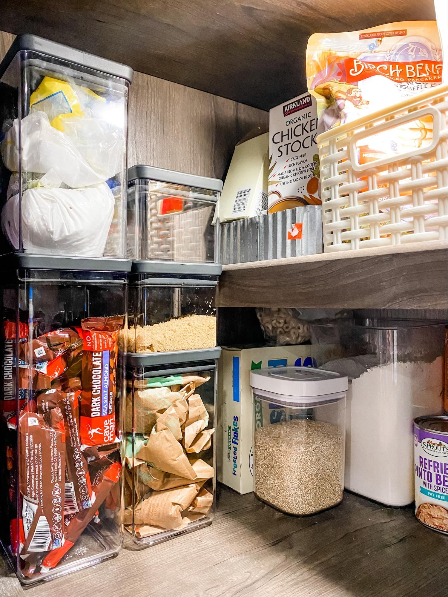 Clear plastic pantry containers holding food items.
