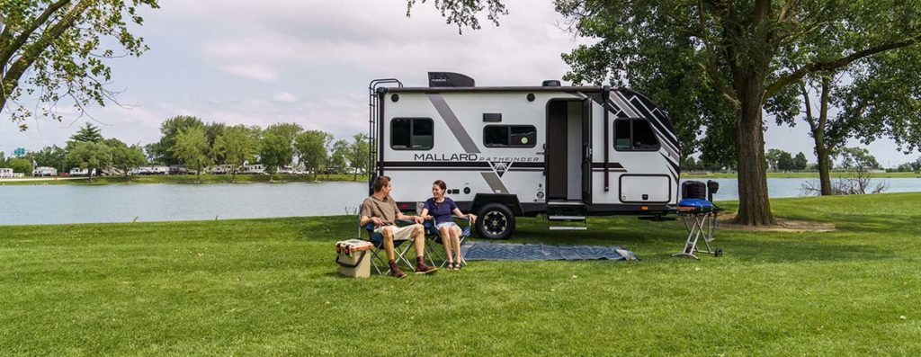Exterior of a Mallard Pathfinder, a small and ultralight RV parked in the grass.
