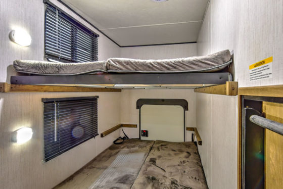 Bunkroom in a Pioneer travel trailer, providing cozy sleeping quarters for multiple occupants.