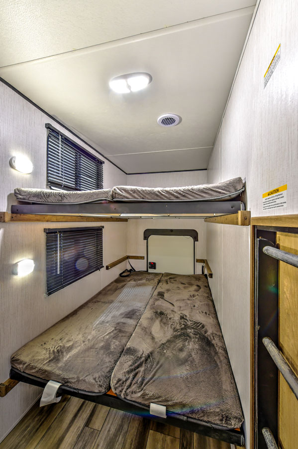 Bunkroom in a Pioneer travel trailer, providing cozy sleeping quarters for multiple occupants.