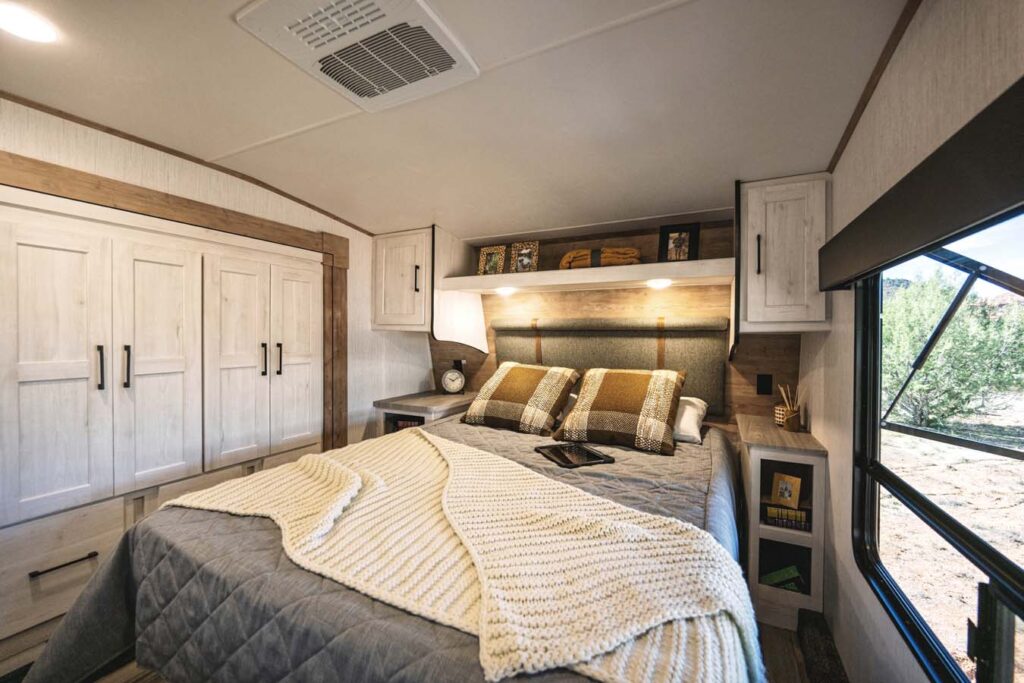 Interior view of the 2025 Heartland RV Bighorn 391MFB Fifth Wheel bedroom with a queen-size bed and elegant décor.